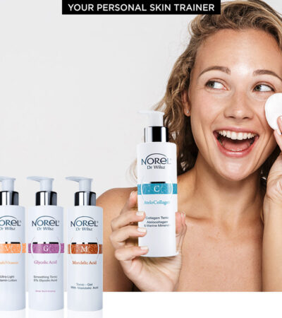 Image of nice half-naked woman laughing and using facial lotion isolated over white background